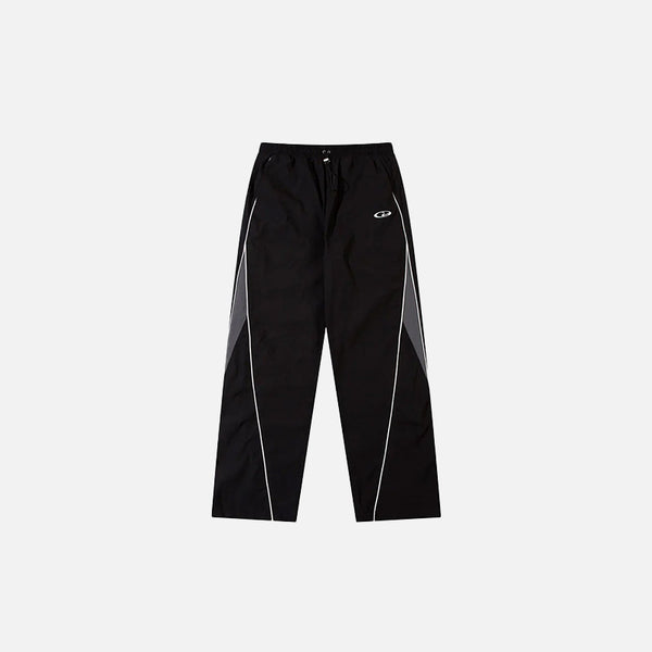 Front view of the Y2K Black Patchwork Sports Pants in a gray background 