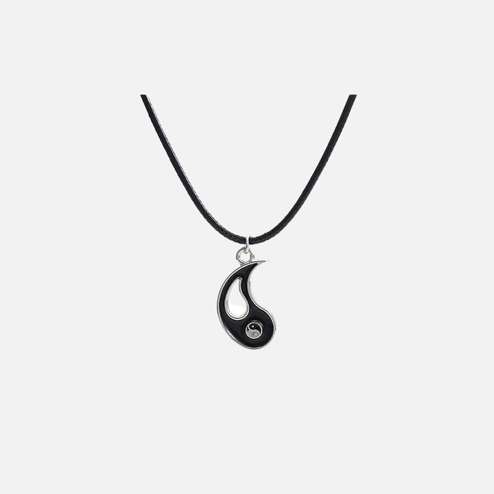 Front view of the Yin-Yang Puzzle Pendant Necklace in a gray background