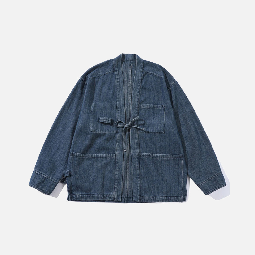 Front view of the blue Relaxed Utility Wrap Jacket in a gray background