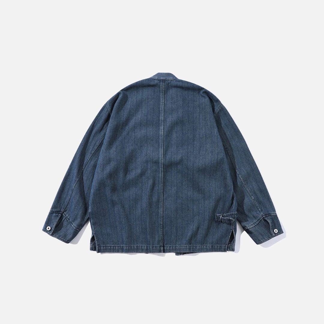 Back view of the blue Relaxed Utility Wrap Jacket in a gray background