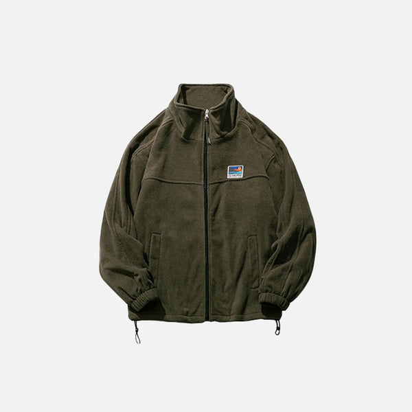 Front view of the army green Urban Explorer Jacket in a gray background 