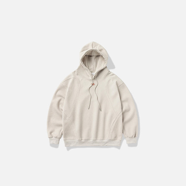 Front view of the beige Zen Mod Hoodie in a gray background