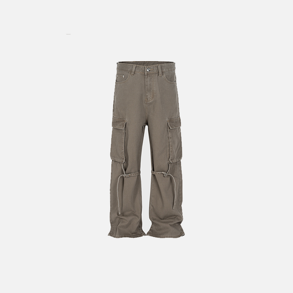 Front view of the brown Loose Washed Pleated Jeans in a gray background