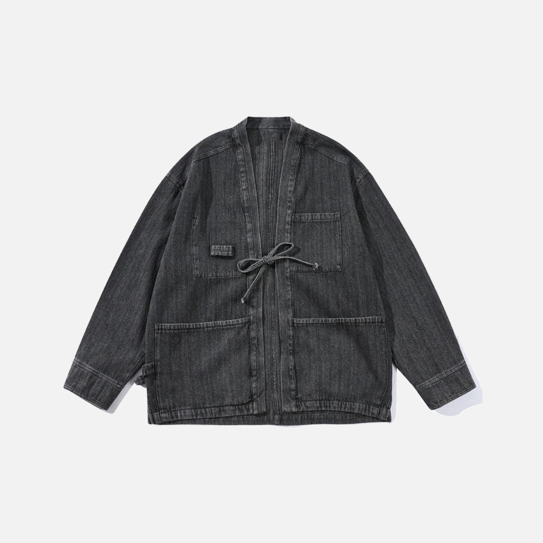 Front view of the black Relaxed Utility Wrap Jacket in a gray background