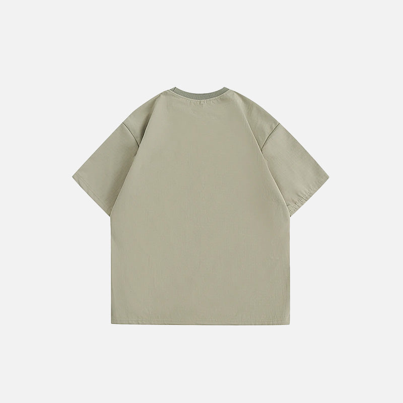 Back view of the green Vintage Loose Pocket T-shirt in a gray background