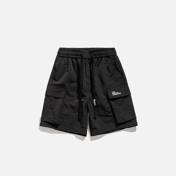 Front view of the black Essential Utility Cargo Shorts in a gray background