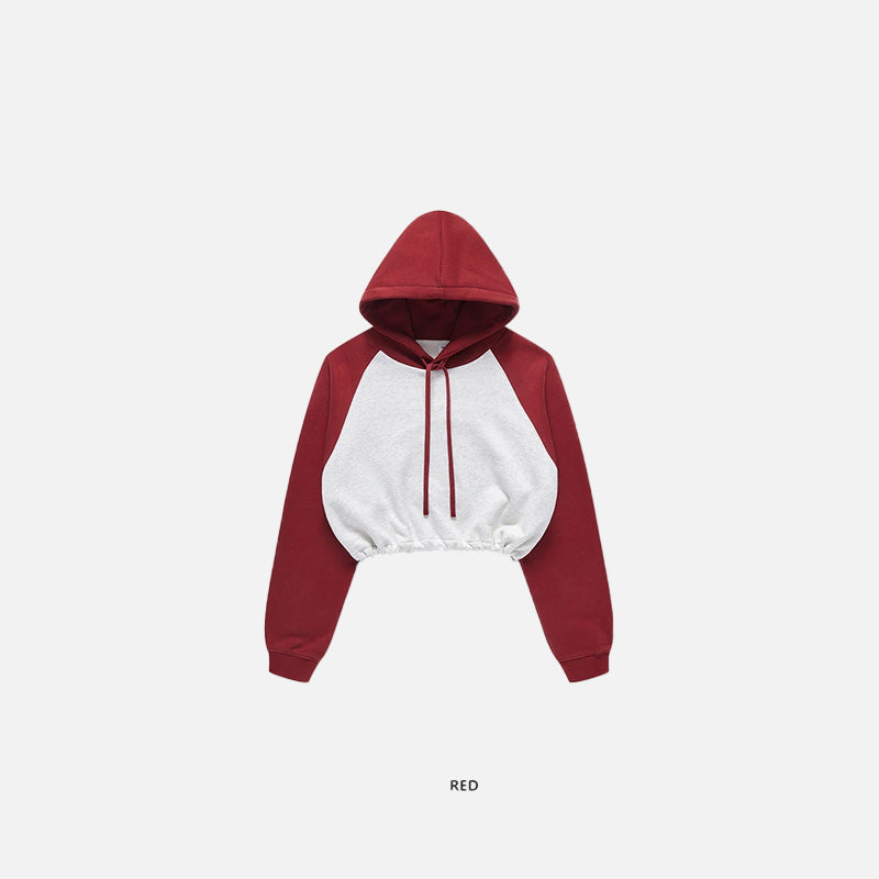 Front view of the red Women's Brick Color block Crop Hoodie  in a gray background