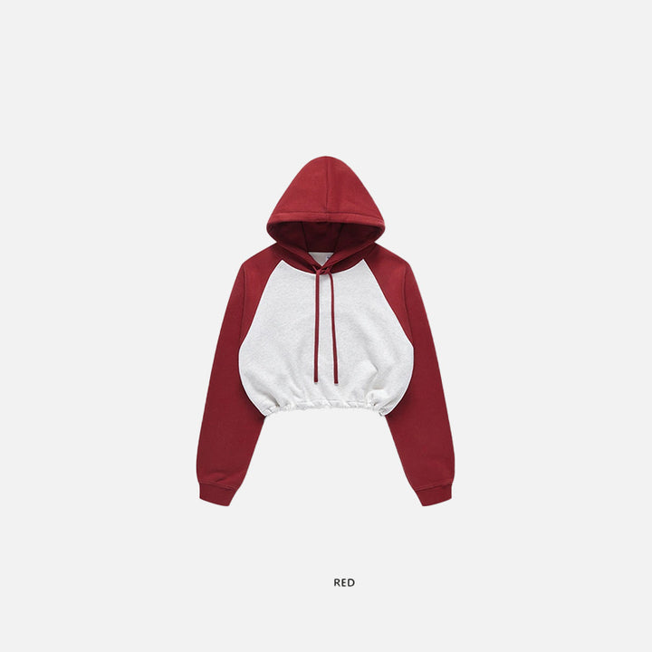 Front view of the red Women's Brick Color block Crop Hoodie  in a gray background