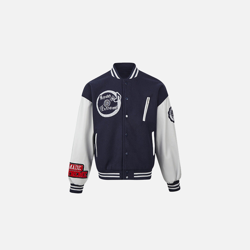 Front view of the navy blue Extreme Varsity Jacket in a gray background