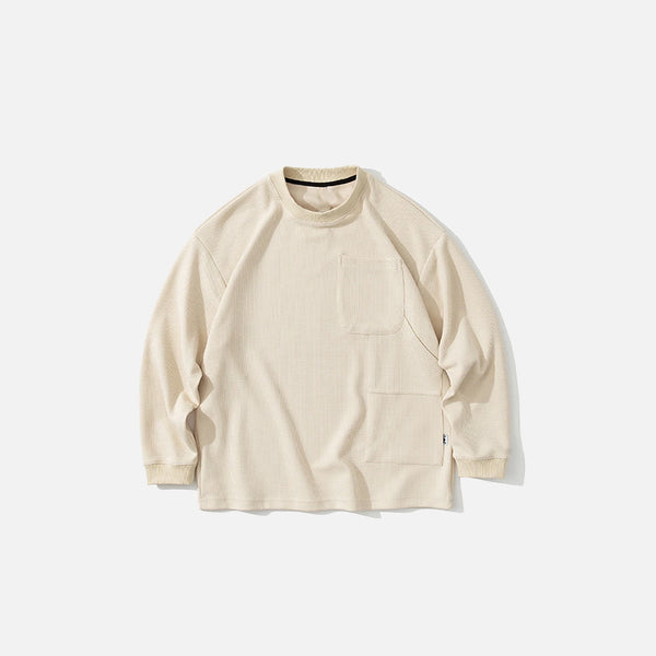 Front view of the beige Timeless Pocket Sweatshirt in a gray background