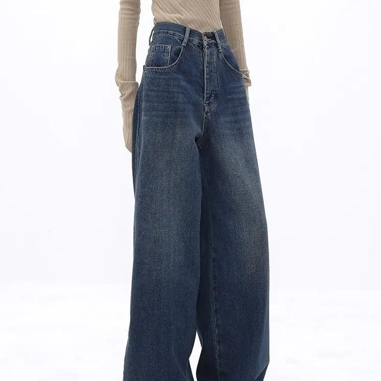 Model wearing the blue Retro Dark Washed Jeans in a gray background