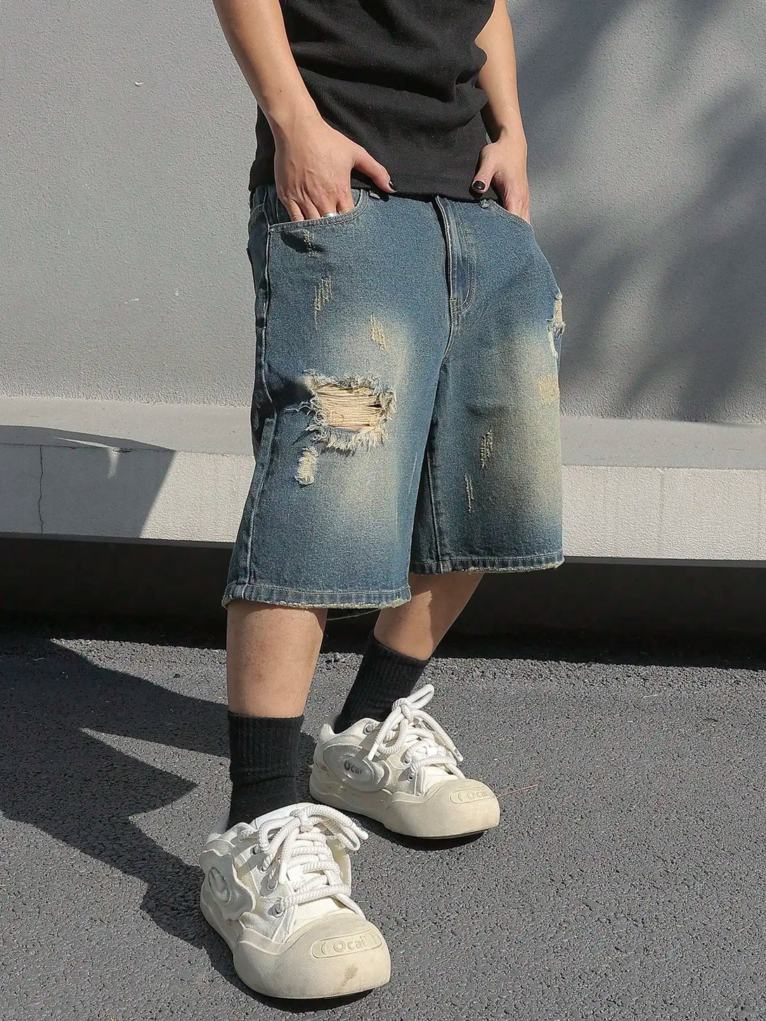 Model wearing the blue Y2K Worn Out Street Shorts 