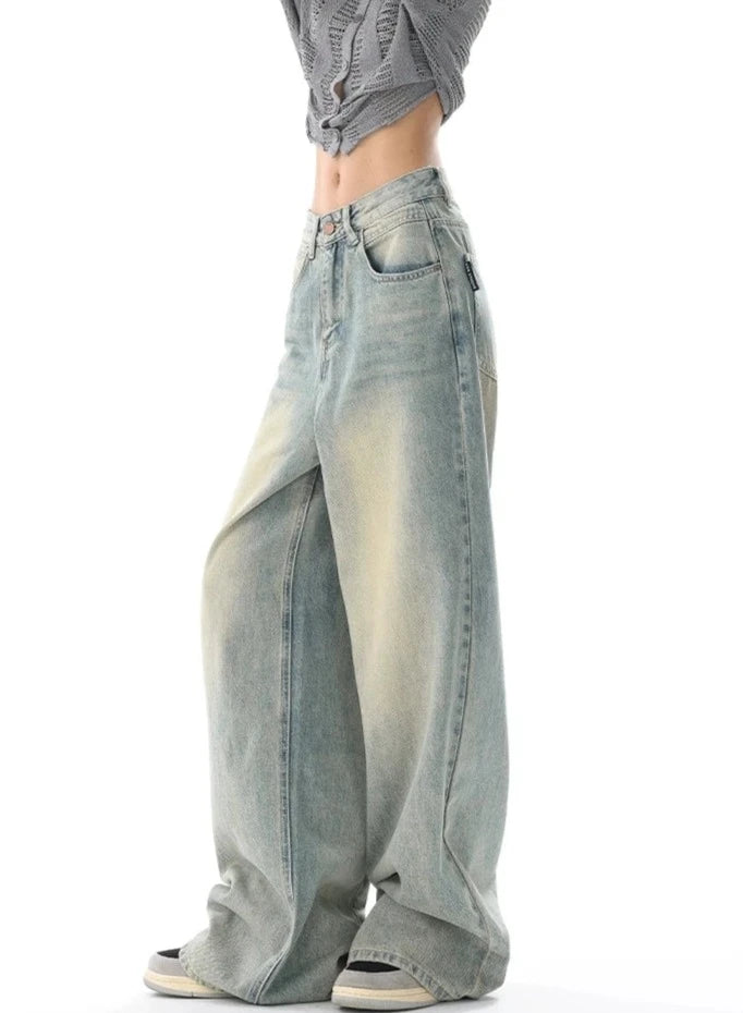 Model wearing the light blue Ultra Wide-Leg Baggy Denim Jeans in a gray background