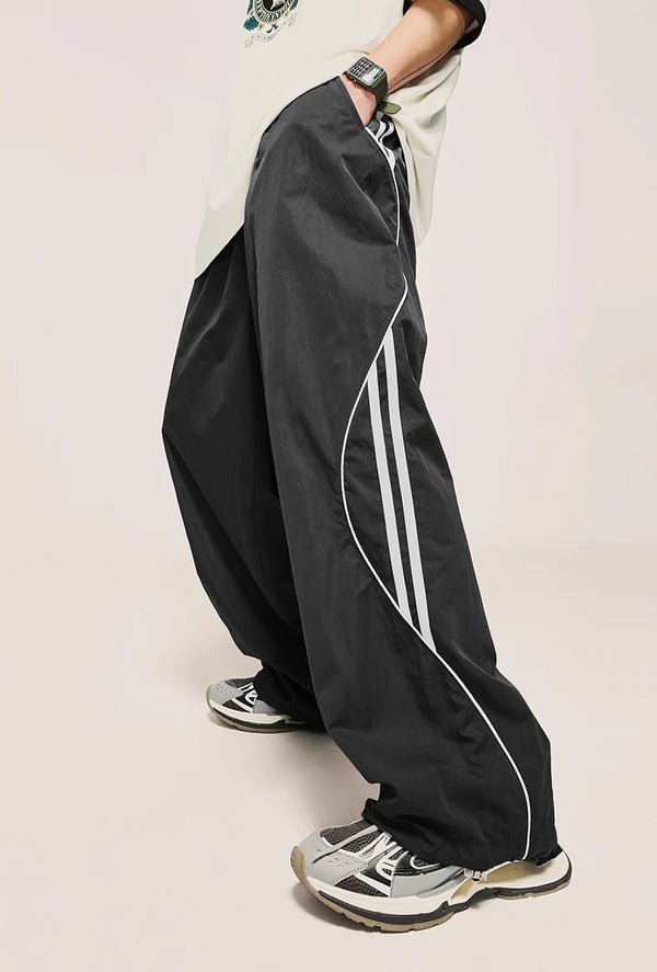 Model wearing the dark grey Loose Side Striped Baggy Pants