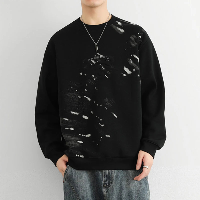 Model wearing the black Abstract Paint Splatter Sweatshirt