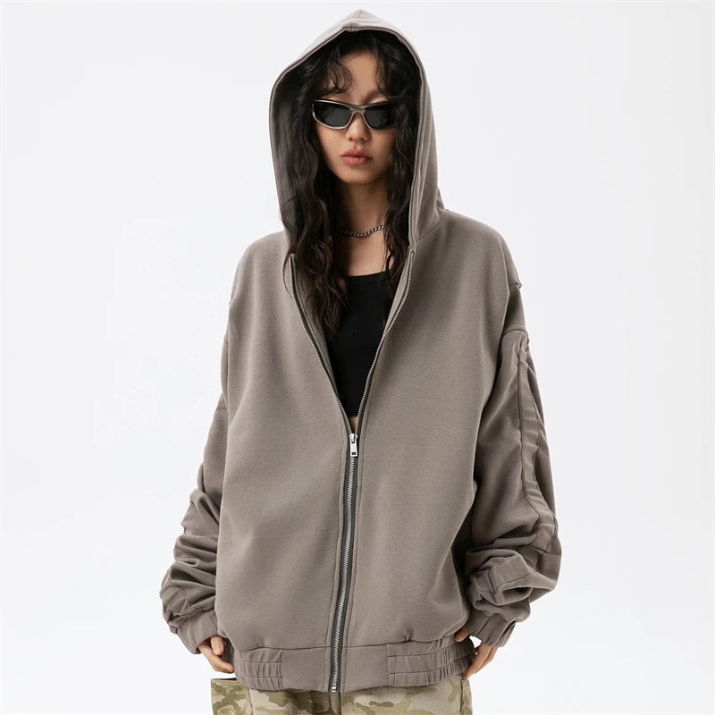 Model wearing the dark gray Edgy Urban Zip-Up Hoodie in a gray background