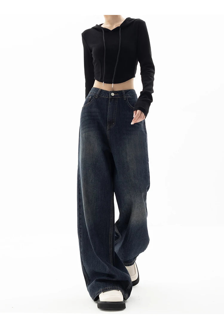 Model wearing the blue Ultra Baggy Denim Jeans in a gray background