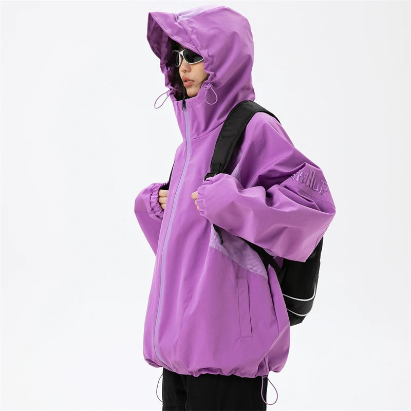 A girl wearing the purple Patchwork Solid Thin Windbreaker Jacket from DAXUEN while holding a bag.