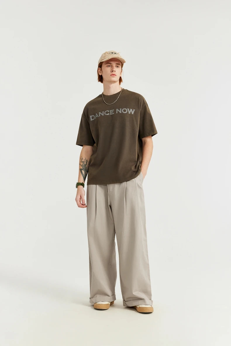 Model wearing the khaki Loose Retro Solid Pants in a gray background 