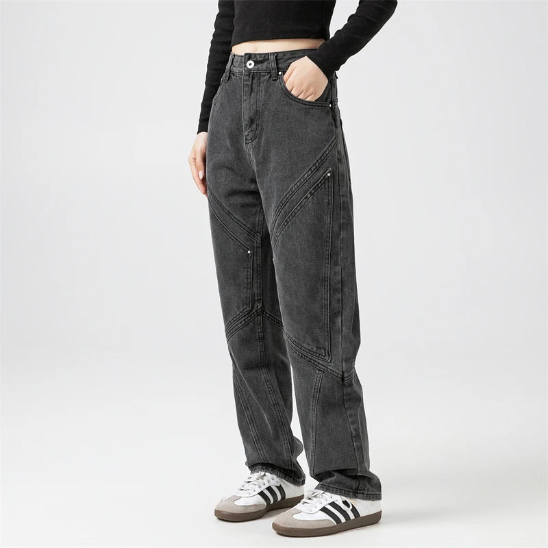 Model wearing the black Y2k Rivet Pocket Jeans in a gray background 