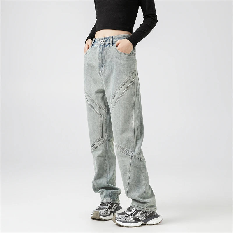 Model wearing the blue Y2k Rivet Pocket Jeans in a gray background 