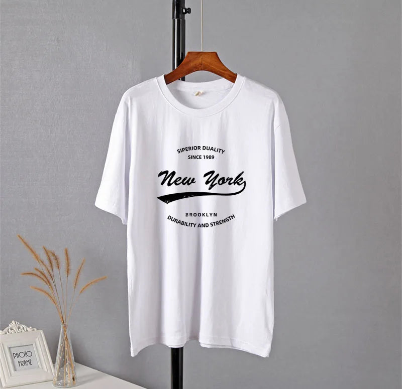 Front view of the white Vibrant New York Graphic T-shirt in a gray background