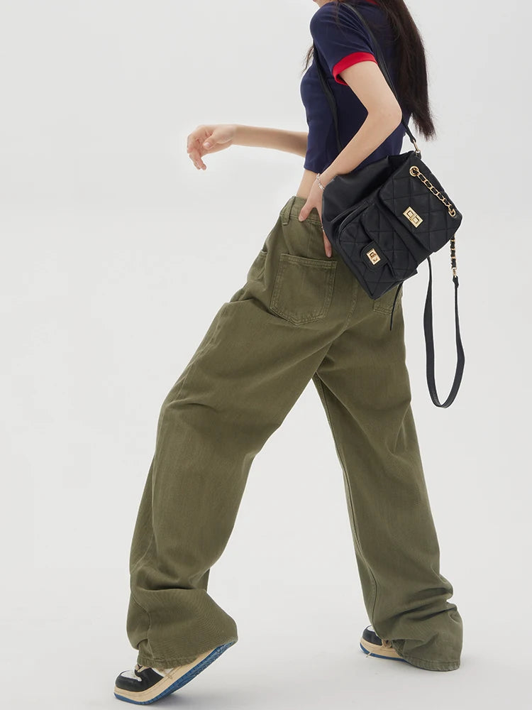 Model wearing the Baggy Olive Green Wide-Leg Jeans in a gray background