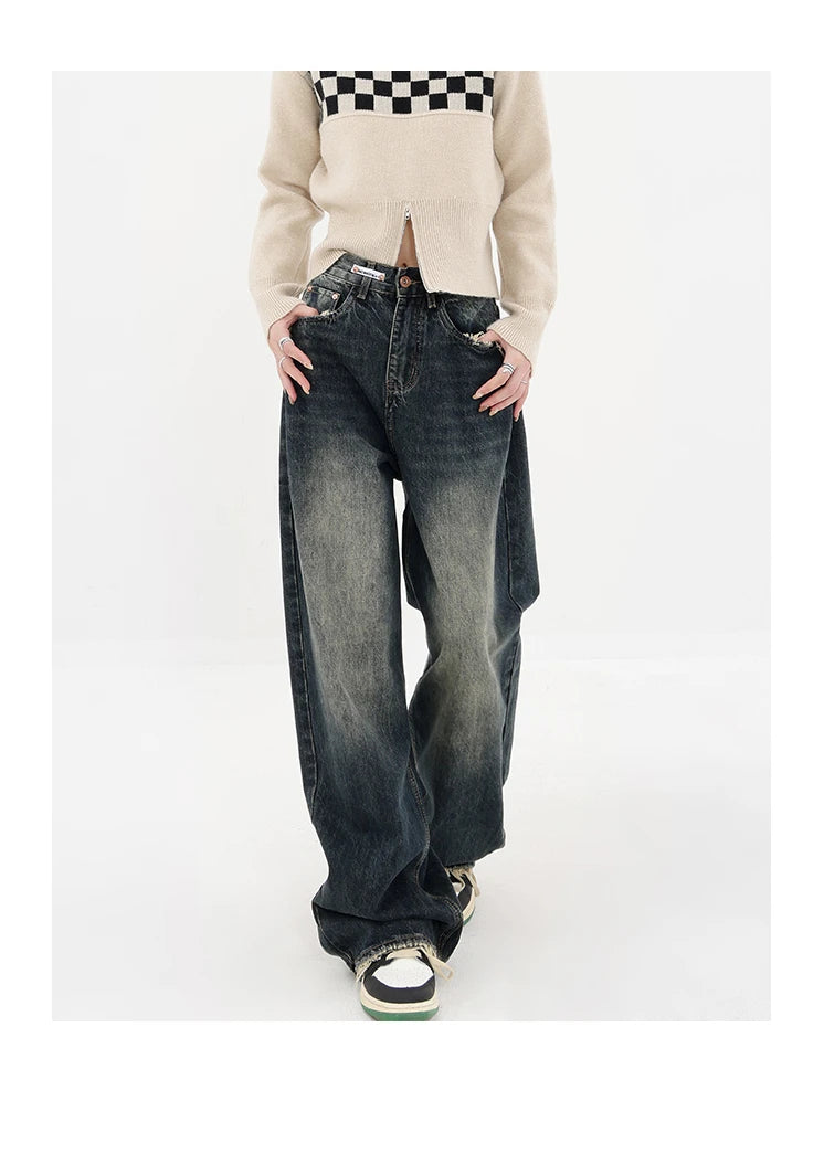 Model wearing the deep blue Stone Wide-Leg Jeans in a gray background