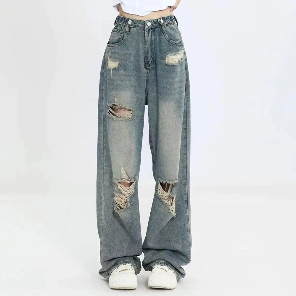 Model wearing the blue Ripped Hole-Knee Baggy Jeans in a gray background