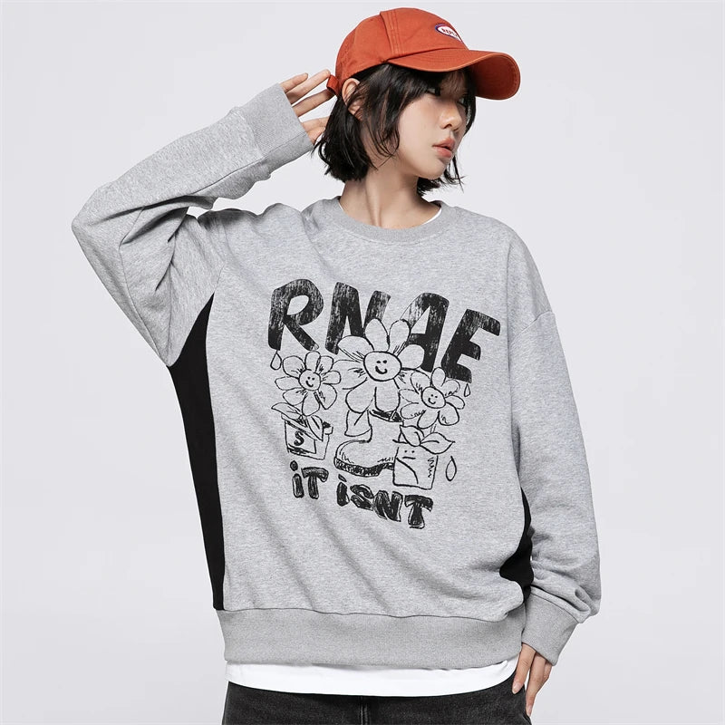 Model wearing the grey Floral Smiley Sweatshirt in a gray background