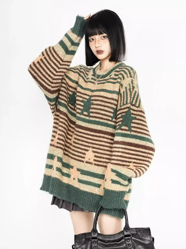 Model wearing the green Starry Strips Oversized Sweater in a gray background