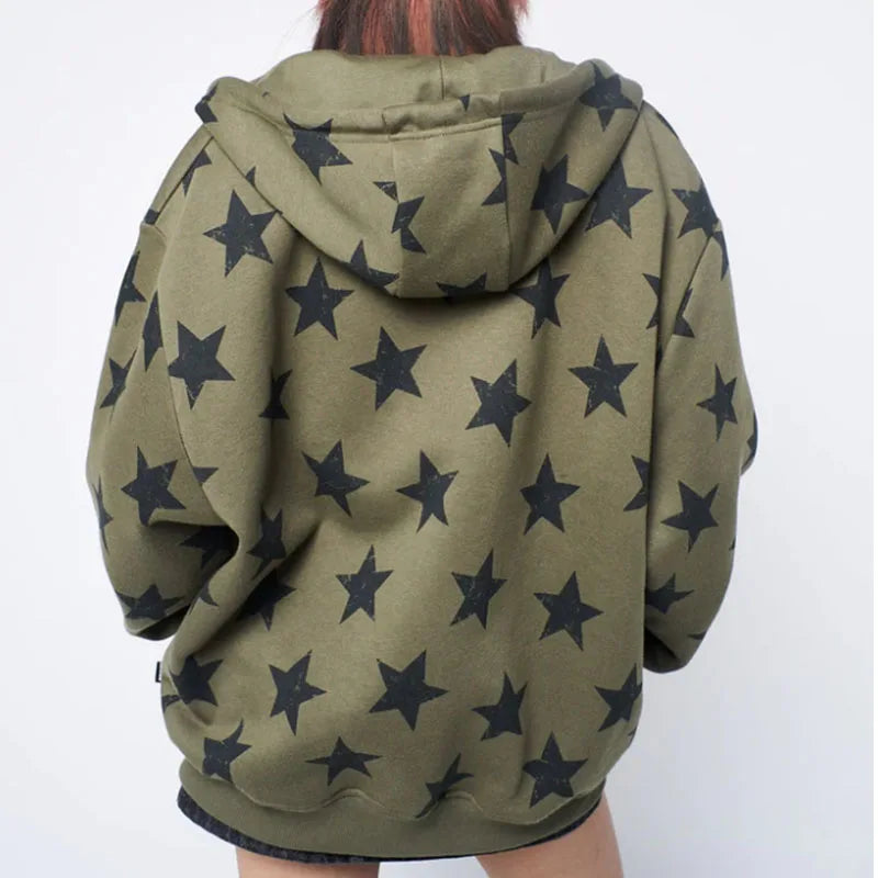 Model wearing the olive green Star-Print Oversized Sweatshirt in a gray background