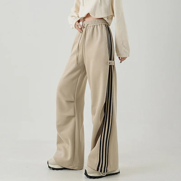 Model wearng the khaki Wide-Leg Track Pants in a gray background