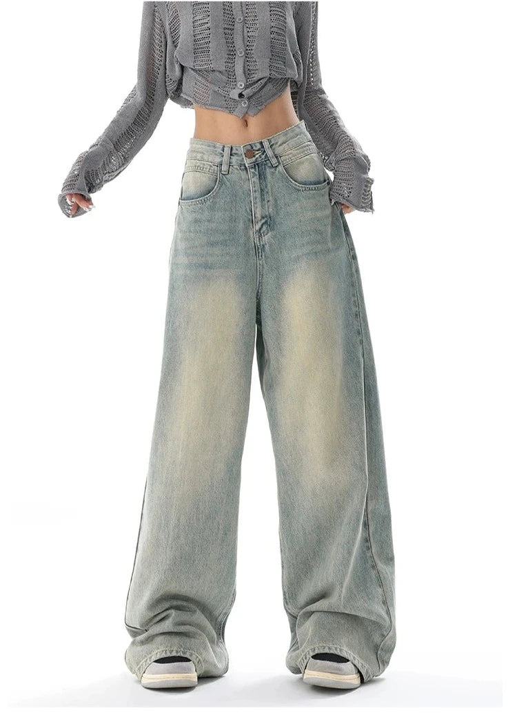 Model wearing the light blue Ultra Wide-Leg Baggy Denim Jeans in a gray background