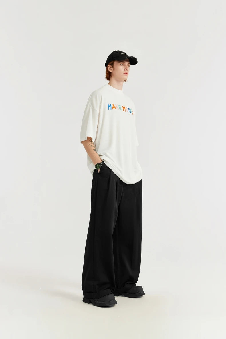 Model wearing the black Loose Retro Solid Pants in a gray background 