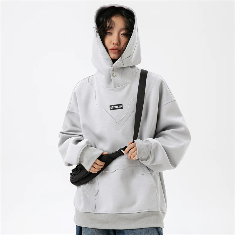 Model wearing the light gray Urban Chic Oversized Hoodie in a gray background