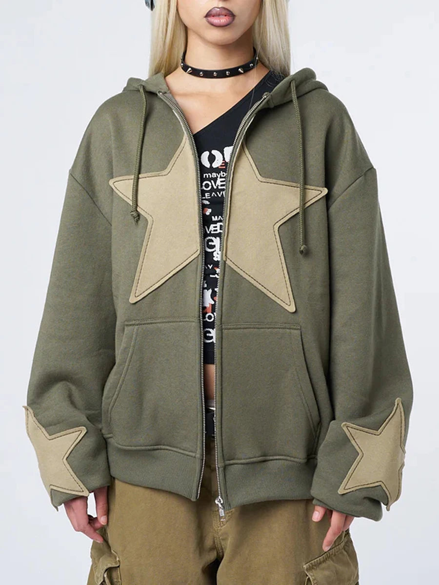 Model wearing the green Star-Patch Zip-Up Sweatshirt in a gray background