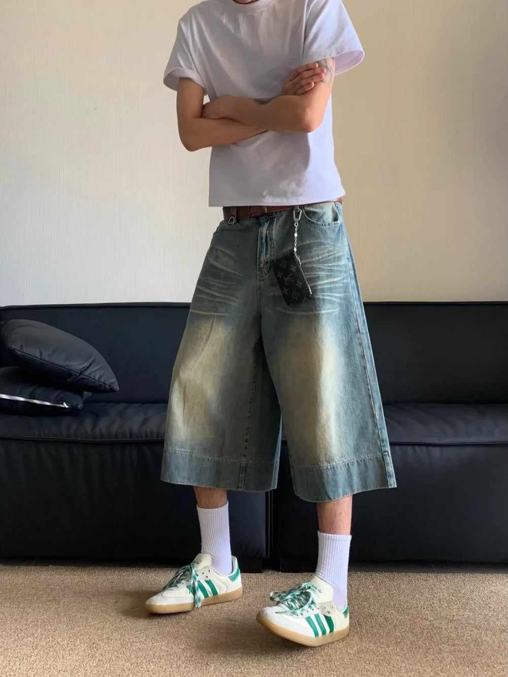 A model standing wearing the Washed Blue Wide-leg Jorts from DAXUEN