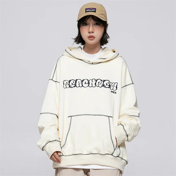 Model wearing the beige Chill Zone Graphic Hoodie in a gray background