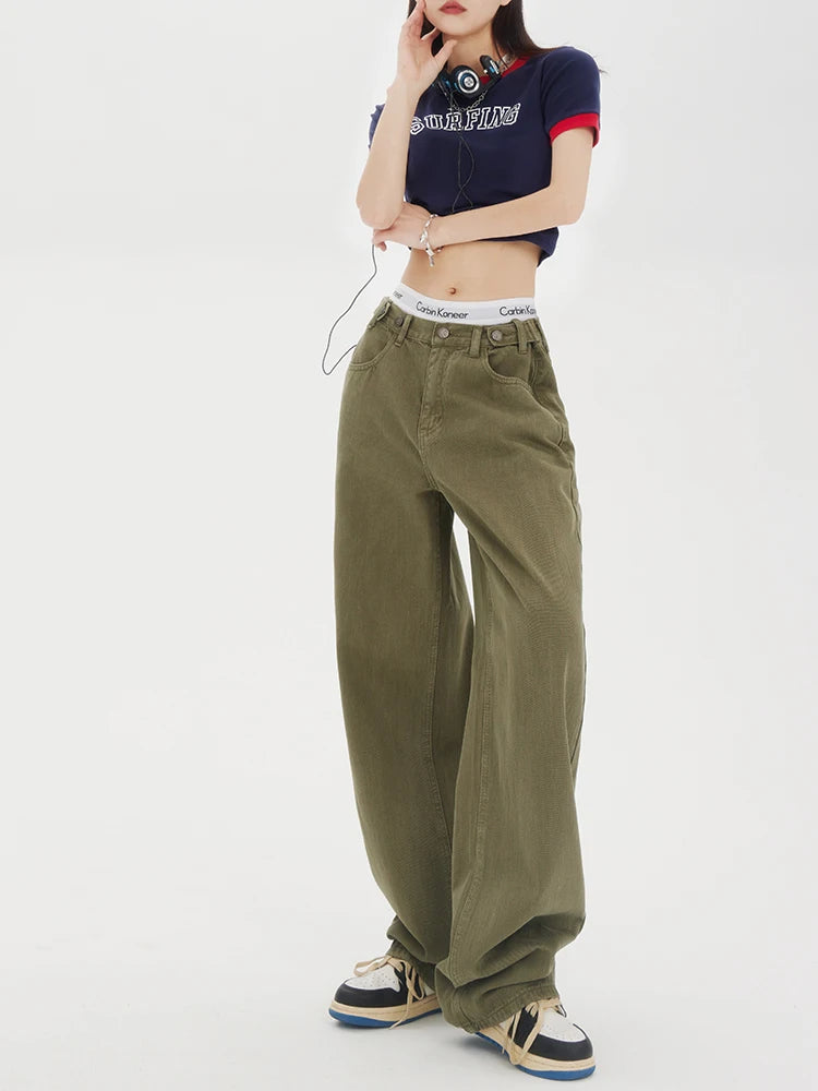 Model wearing the Baggy Olive Green Wide-Leg Jeans in a gray background