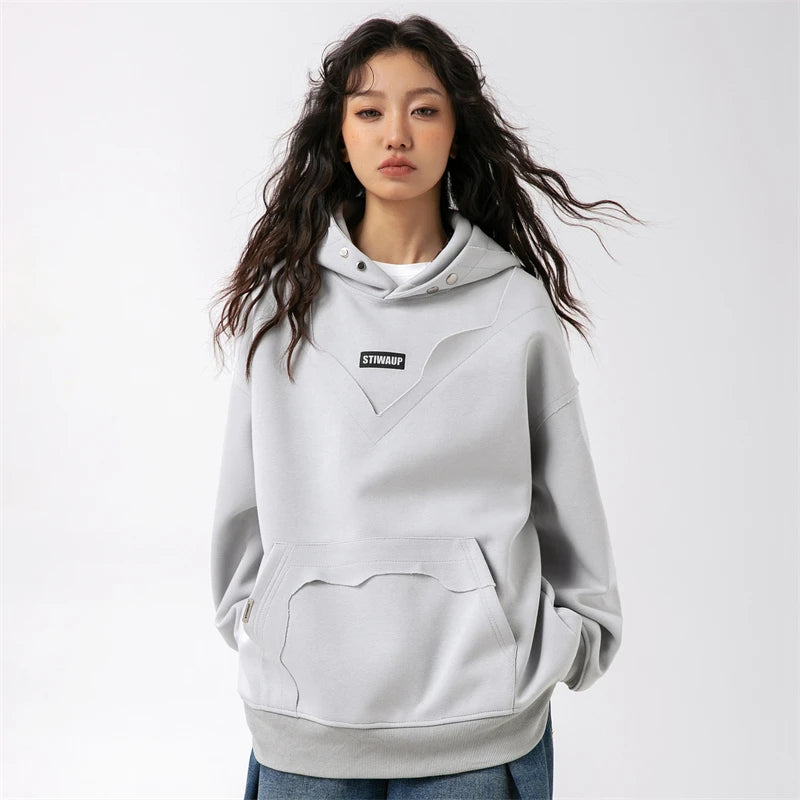 Model wearing the light gray Urban Chic Oversized Hoodie in a gray background