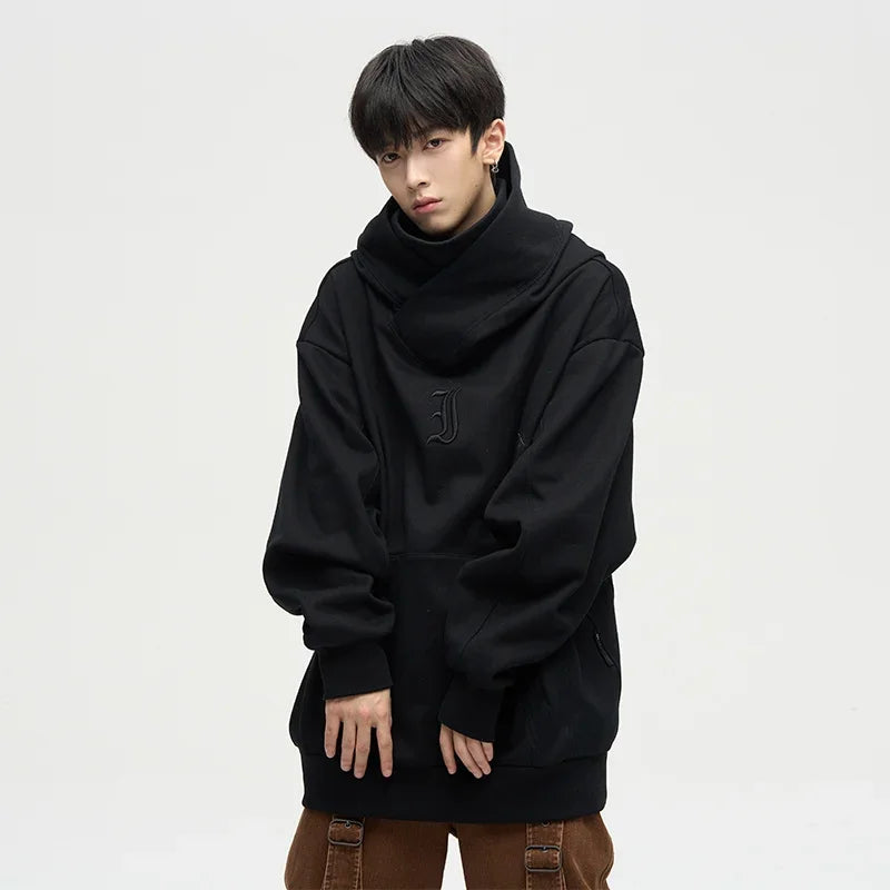 Model wearing the black Oversized Cowl Hoodie in a gray background