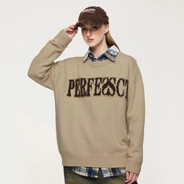 Model wearing the khaki Distressed Lettered Sweater 