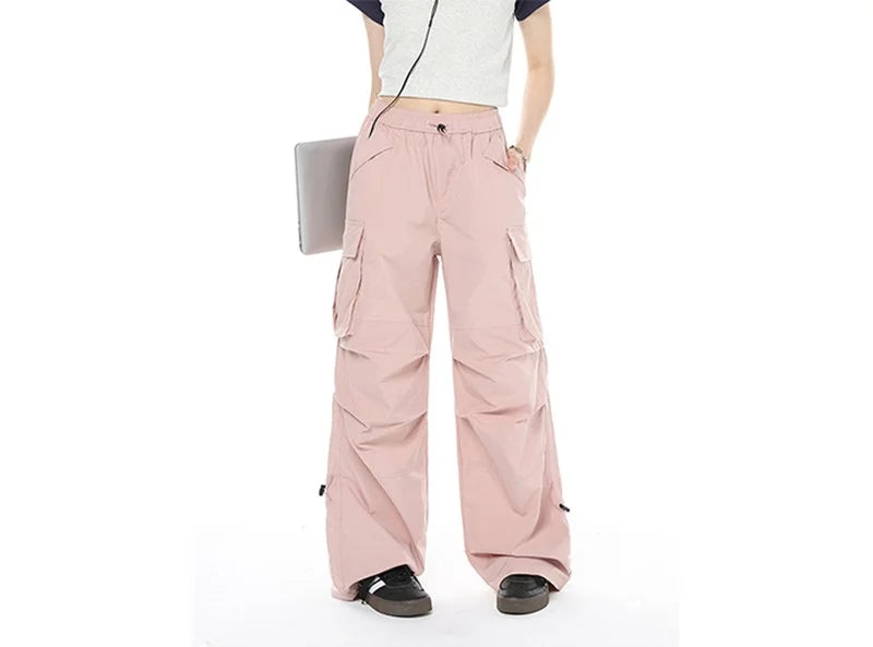 Model Wearing The pink Loose Fit Cargo Denim Pants in a gray background