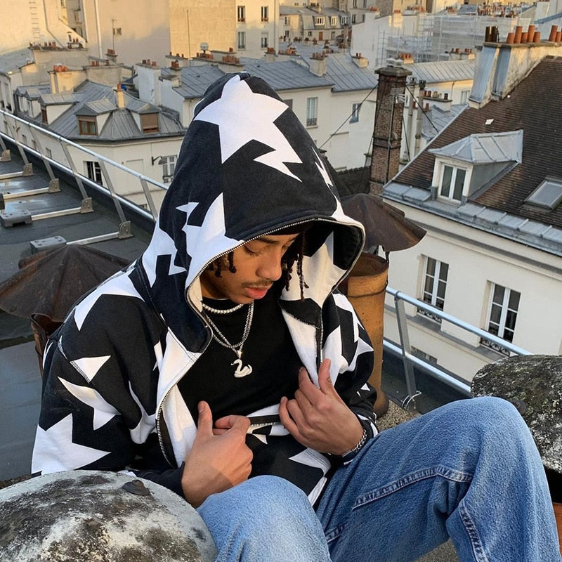 A model showing the details of the black Zip Up Grunge Hoodie while sitting on the roof of a building