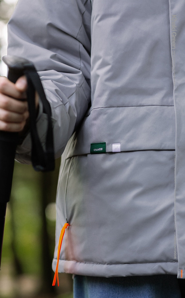 A girl carrying a stick and wearing rain captain jacket