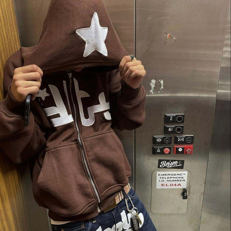 A model wearing the coffe DTY Hoodies while standing in the elevator